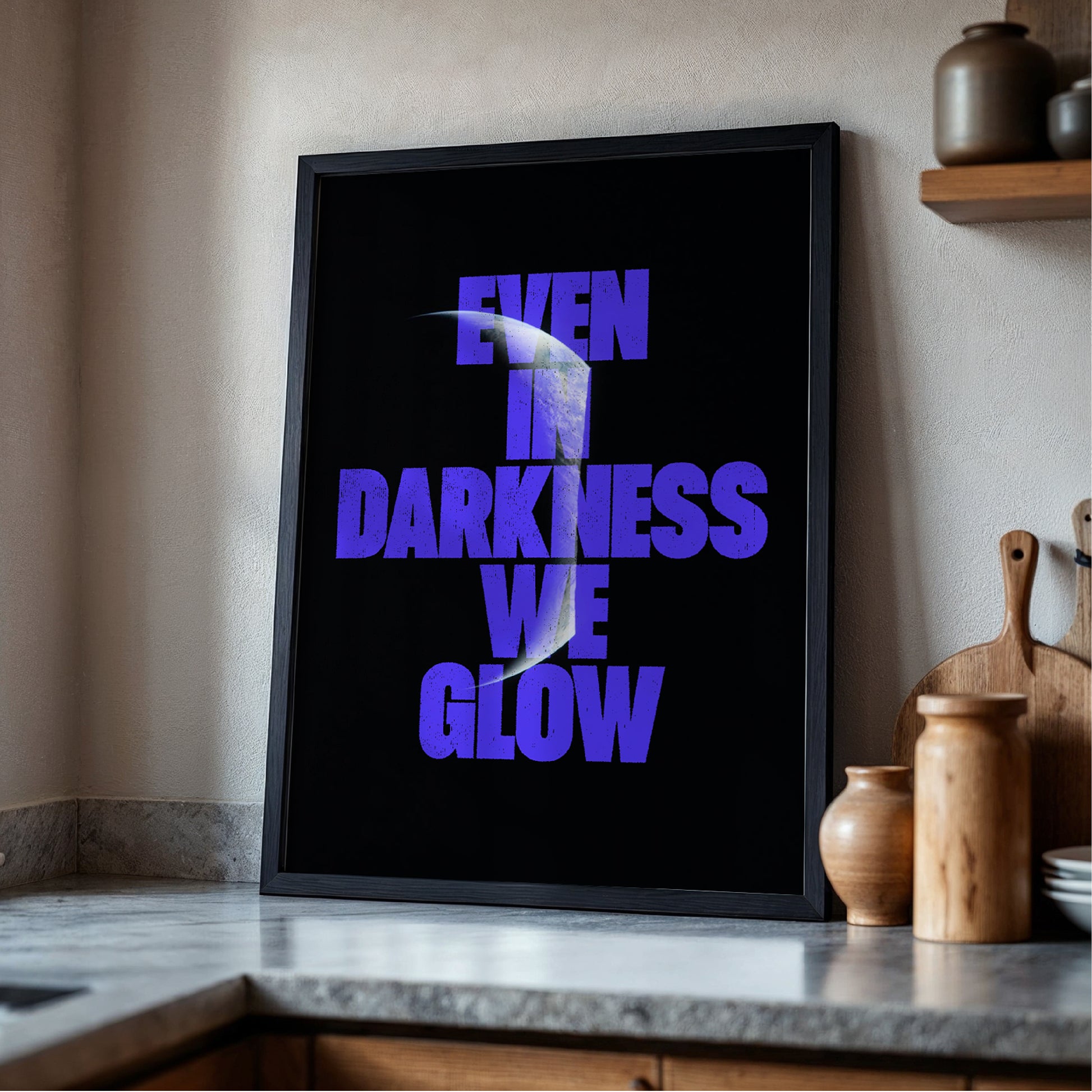 Even In Darkness We Glow print displayed in frame - space typography wall art